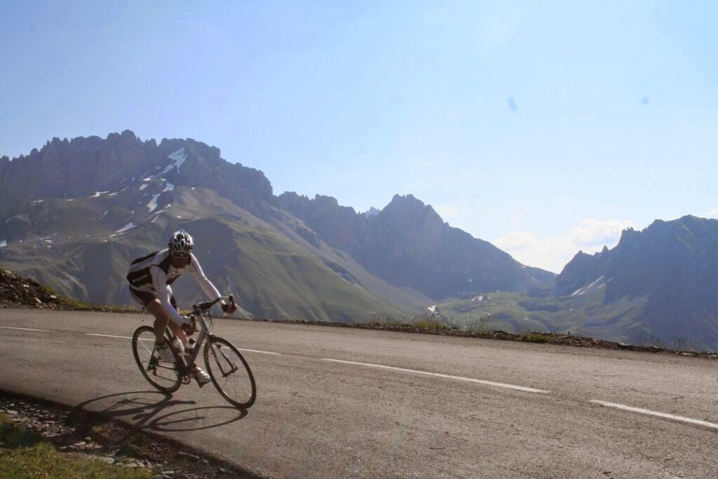 A cyclist during a descent in the French Alps before reaching Alpe d'Huez