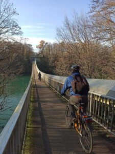 Cross the Lignon footbridge by bike