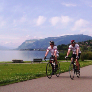Cyclists riding along the bikeway by Lake Bourget
