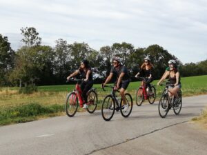 Cyclists riding a variety of types of bikes